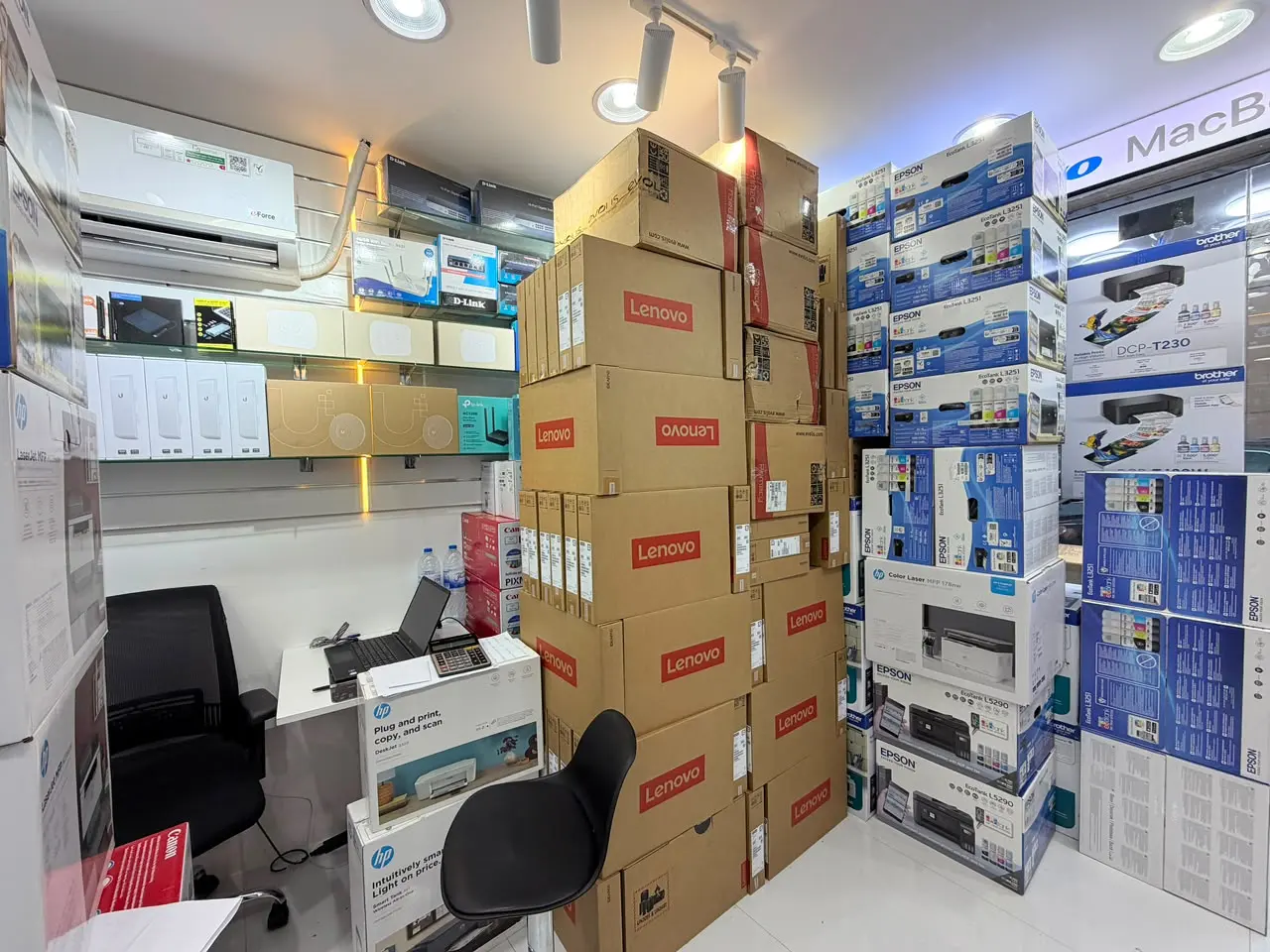 The sales desk inside the Colion International showroom in Deira, with Lenovo, Epson and HP stock